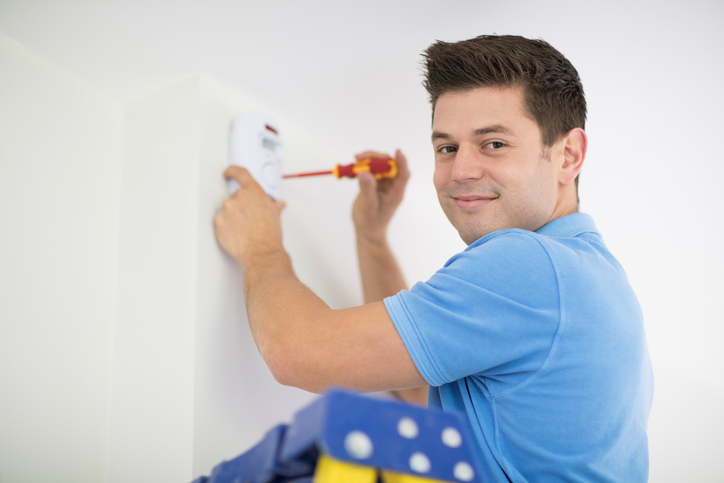 A man tests an in-home security system